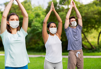 Image showing group of people doing yoga at summer park