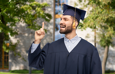 Image showing happy graduate student pointing his finger up