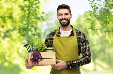 Image showing happy gardener or farmer with box of garden tools