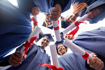 Image showing graduate students in mortar boards with diplomas