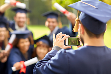 Image showing graduate students taking photo with smartphone