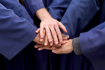 Image showing inernational graduate students stacking hands