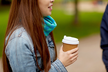 Image showing close up of young woman drinking takeaway coffee