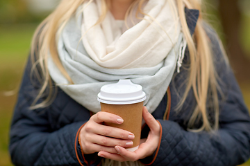 Image showing close up of young woman drinking takeaway coffee