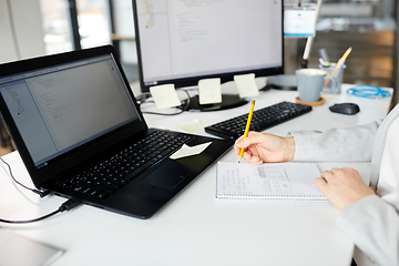 Image showing businesswoman with notebook and laptop at office