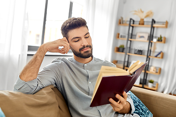 Image showing man reading book at home