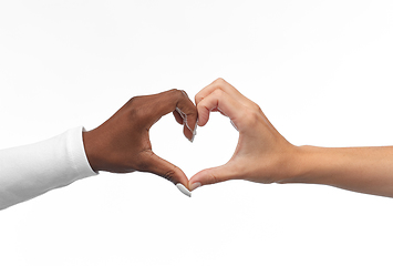 Image showing black and white hands making heart gesture