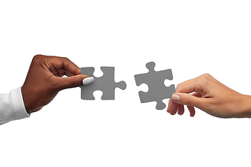 Image showing black and white hands matching pieces of puzzle
