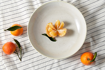 Image showing still life with mandarins on plate over drapery