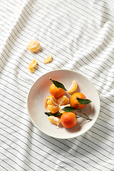 Image showing still life with mandarins on plate over drapery