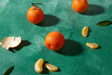 Image showing still life with mandarins on green background