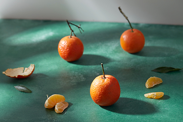 Image showing still life with mandarins on green background