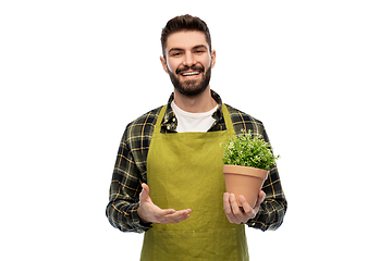 Image showing happy smiling male gardener with flower in pot