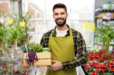 Image showing happy gardener or seller with box of garden tools