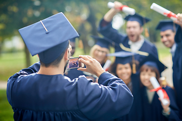 Image showing graduate students taking photo with smartphone