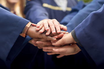 Image showing inernational graduate students stacking hands