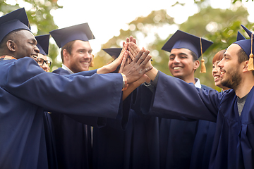 Image showing international graduate students making high five