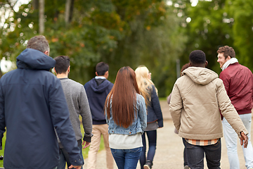 Image showing happy friends walking along autumn park