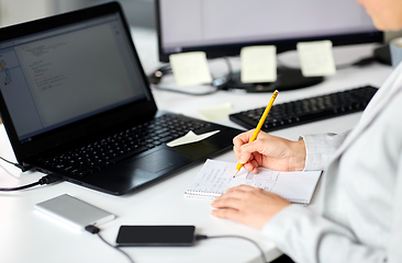 Image showing businesswoman with notebook and laptop at office