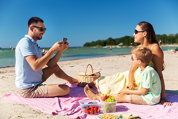Image showing family with smartphone photographing on beach