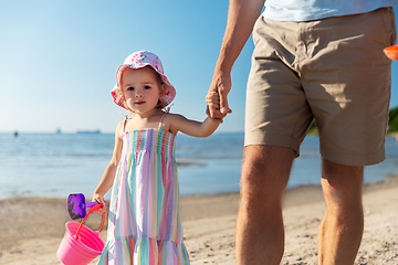 Image showing father walking with little daughter on beach