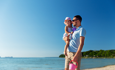 Image showing happy father with little daughter on beach