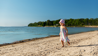 Image showing happy baby girl running on summer beach