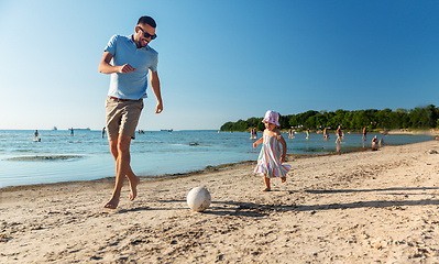 Image showing happy father and daughter playing ball on beach