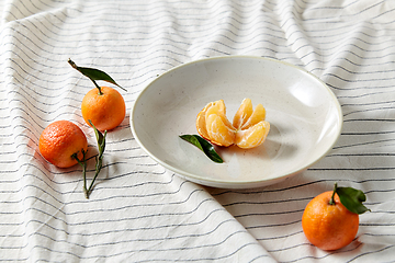 Image showing still life with mandarins on plate over drapery