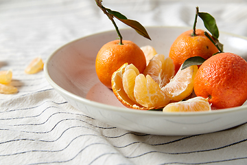 Image showing still life with mandarins on plate over drapery