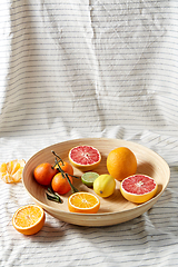 Image showing close up of citrus fruits on wooden plate