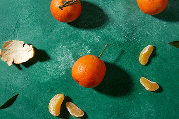 Image showing still life with mandarins on green background