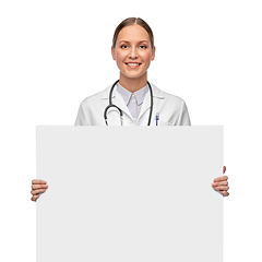 Image showing happy smiling female doctor holding white board