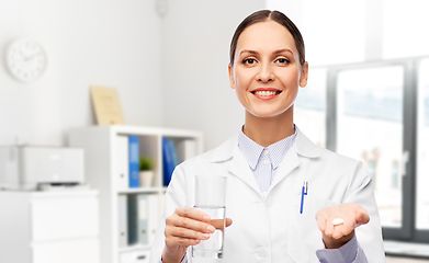 Image showing female doctor with medicine and glass of water