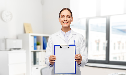 Image showing smiling female doctor with clipboard at hospital