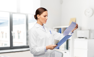 Image showing female doctor with medical report at hospital