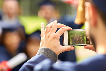 Image showing graduate students taking photo with smartphone