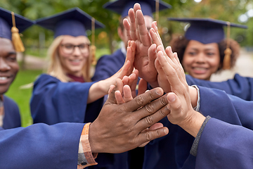 Image showing international graduate students making high five