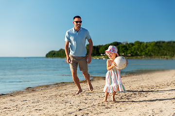 Image showing happy father and daughter playing ball on beach