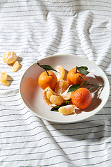 Image showing still life with mandarins on plate over drapery