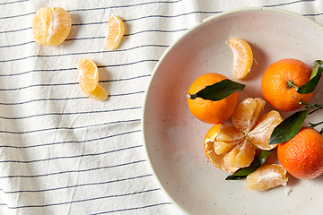 Image showing still life with mandarins on plate over drapery