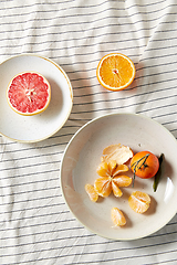 Image showing still life with mandarins and grapefruit on plate