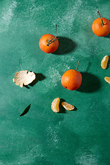 Image showing still life with mandarins on green background