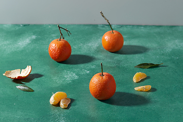 Image showing still life with mandarins on green background