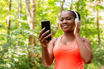 Image showing african american woman with headphones and phone