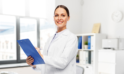 Image showing smiling female doctor with clipboard at hospital