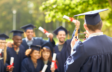 Image showing graduate students taking photo with smartphone