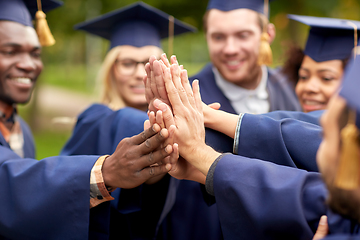 Image showing international graduate students making high five