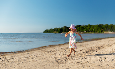 Image showing happy baby girl running on summer beach