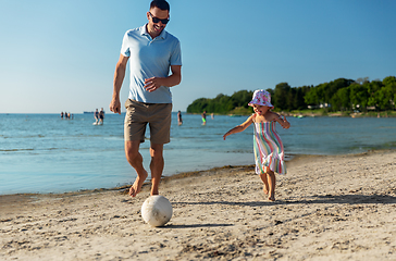 Image showing happy father and daughter playing ball on beach